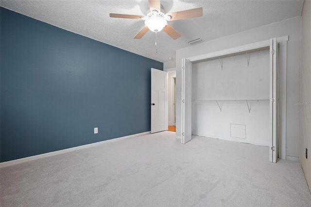 17 Freshwater Dr, Palm Harbor, FL 34684 - unfurnished bedroom with carpet flooring, a closet, a textured ceiling, and a ceiling fan