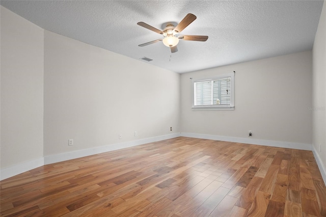 17 Freshwater Dr, Palm Harbor, FL 34684 - unfurnished room with ceiling fan, a textured ceiling, and light wood finished floors