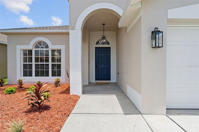 1800 Loch Haven Ct, Trinity, FL 34655 - doorway to property with stucco siding and a garage