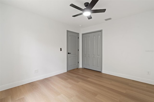 1800 Loch Haven Ct, Trinity, FL 34655 - unfurnished bedroom featuring light wood-style flooring, a closet, and a ceiling fan