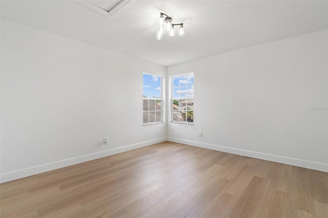 1800 Loch Haven Ct, Trinity, FL 34655 - empty room featuring light wood-style flooring and a textured ceiling