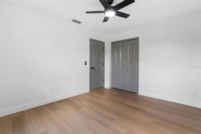 1800 Loch Haven Ct, Trinity, FL 34655 - unfurnished bedroom featuring light wood finished floors, ceiling fan, and a closet