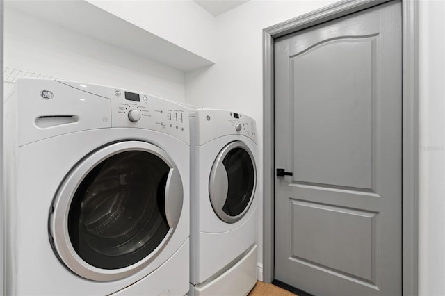 1800 Loch Haven Ct, Trinity, FL 34655 - laundry room with washing machine and dryer and light wood-type flooring