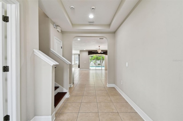 4544 Vermillion Sky Dr, Wesley Chapel, FL 33544 - corridor featuring light tile patterned flooring, a tray ceiling, and stairway