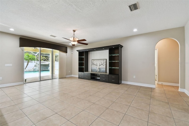 4544 Vermillion Sky Dr, Wesley Chapel, FL 33544 - unfurnished living room with ceiling fan, arched walkways, a textured ceiling, recessed lighting, and light tile patterned floors
