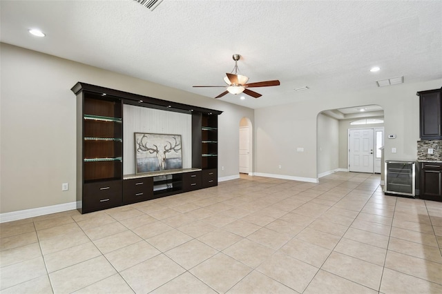4544 Vermillion Sky Dr, Wesley Chapel, FL 33544 - unfurnished living room featuring beverage cooler, arched walkways, ceiling fan, light tile patterned floors, and recessed lighting