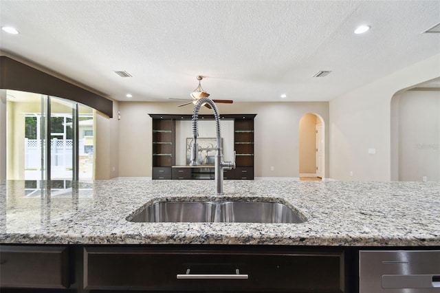 4544 Vermillion Sky Dr, Wesley Chapel, FL 33544 - kitchen featuring arched walkways, ceiling fan, recessed lighting, a textured ceiling, and open floor plan