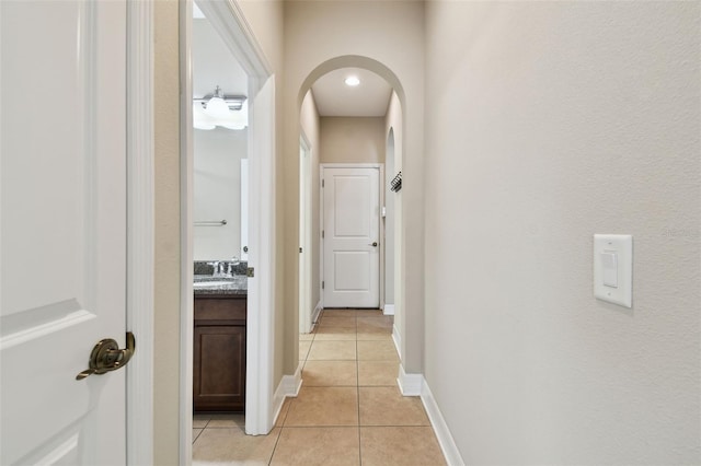 4544 Vermillion Sky Dr, Wesley Chapel, FL 33544 - hallway featuring light tile patterned floors and arched walkways