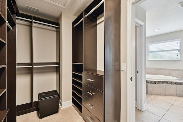 4544 Vermillion Sky Dr, Wesley Chapel, FL 33544 - walk in closet with tile patterned flooring