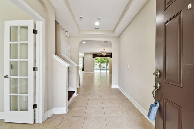 4544 Vermillion Sky Dr, Wesley Chapel, FL 33544 - foyer with ceiling fan, light tile patterned floors, a raised ceiling, and stairway