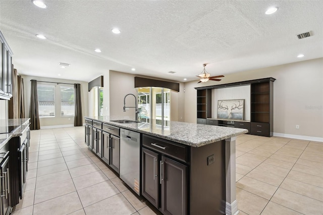 4544 Vermillion Sky Dr, Wesley Chapel, FL 33544 - kitchen with stainless steel dishwasher, light tile patterned floors, a textured ceiling, an island with sink, and ceiling fan