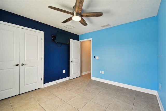4544 Vermillion Sky Dr, Wesley Chapel, FL 33544 - unfurnished bedroom with light tile patterned flooring, a closet, and ceiling fan