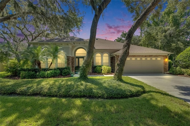 5804 Terncrest Dr, Lithia, FL 33547 - mediterranean / spanish house with a garage, driveway, stucco siding, and a front lawn