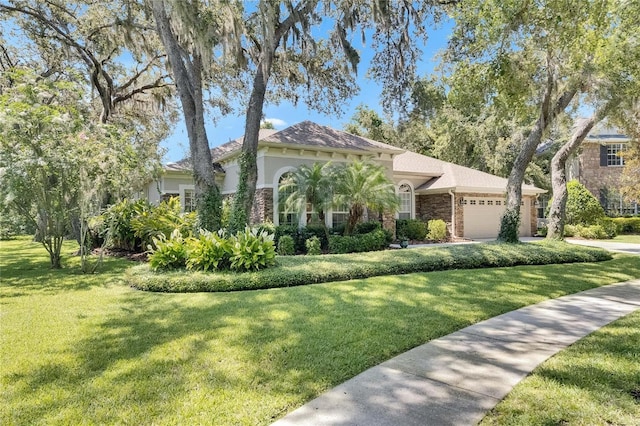 5804 Terncrest Dr, Lithia, FL 33547 - mediterranean / spanish-style home with an attached garage, a front yard, stucco siding, and driveway