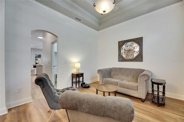 5804 Terncrest Dr, Lithia, FL 33547 - living area with arched walkways, wood finished floors, ornamental molding, and a tray ceiling