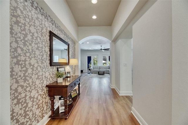 5804 Terncrest Dr, Lithia, FL 33547 - corridor with light wood-type flooring, arched walkways, recessed lighting, and wallpapered walls