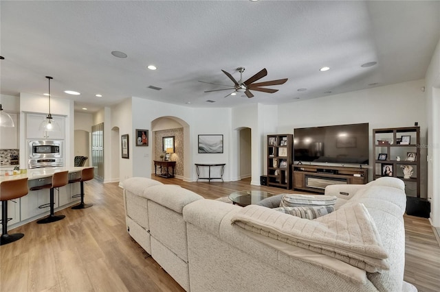 5804 Terncrest Dr, Lithia, FL 33547 - living room featuring arched walkways, ceiling fan, recessed lighting, and light wood-style flooring