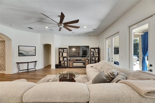 5804 Terncrest Dr, Lithia, FL 33547 - living area featuring arched walkways, wood finished floors, a ceiling fan, recessed lighting, and a textured ceiling