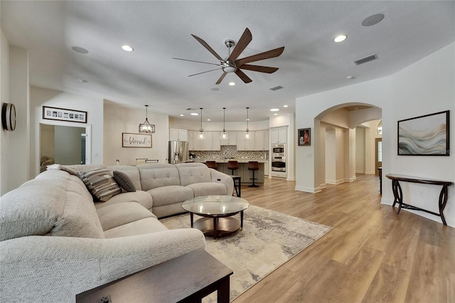 5804 Terncrest Dr, Lithia, FL 33547 - living room with ceiling fan, arched walkways, light wood-type flooring, and recessed lighting