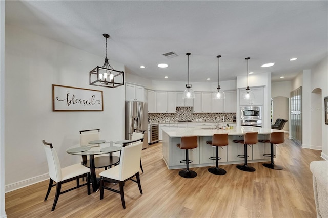 5804 Terncrest Dr, Lithia, FL 33547 - kitchen featuring stainless steel appliances, light countertops, light wood-style flooring, backsplash, and recessed lighting