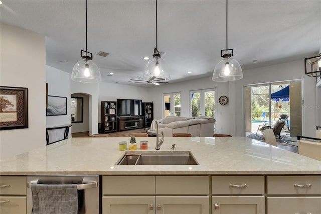 5804 Terncrest Dr, Lithia, FL 33547 - kitchen with open floor plan, dishwasher, light stone countertops, and decorative light fixtures