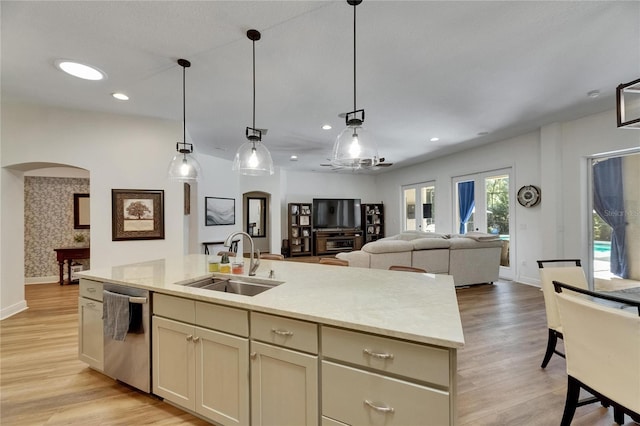 5804 Terncrest Dr, Lithia, FL 33547 - kitchen with dishwasher, arched walkways, a center island with sink, light wood-type flooring, and open floor plan