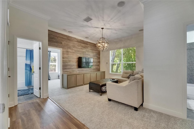 5804 Terncrest Dr, Lithia, FL 33547 - carpeted living area with plenty of natural light, crown molding, a chandelier, wood finished floors, and wooden walls