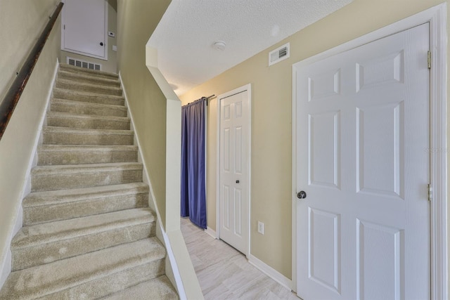 11438 Ivy Flower Loop, Riverview, FL 33578 - stairs with baseboards and a textured ceiling