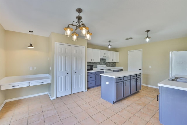 11438 Ivy Flower Loop, Riverview, FL 33578 - kitchen featuring white appliances, light countertops, decorative light fixtures, and decorative backsplash