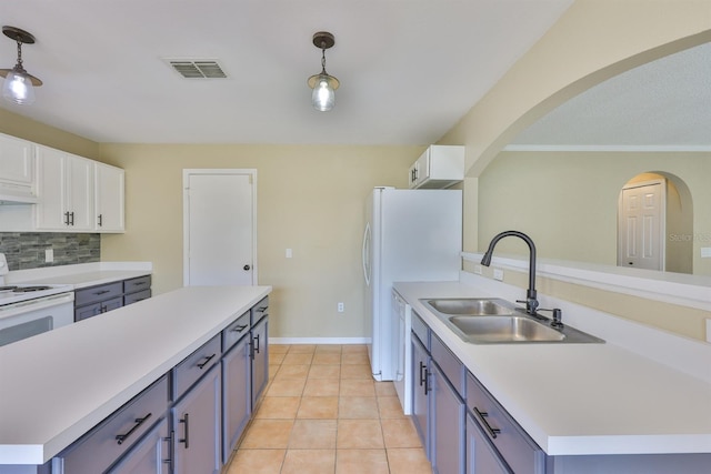 11438 Ivy Flower Loop, Riverview, FL 33578 - kitchen with white cabinets, arched walkways, light countertops, pendant lighting, and decorative backsplash
