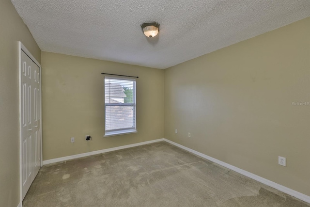 11438 Ivy Flower Loop, Riverview, FL 33578 - carpeted spare room featuring baseboards and a textured ceiling