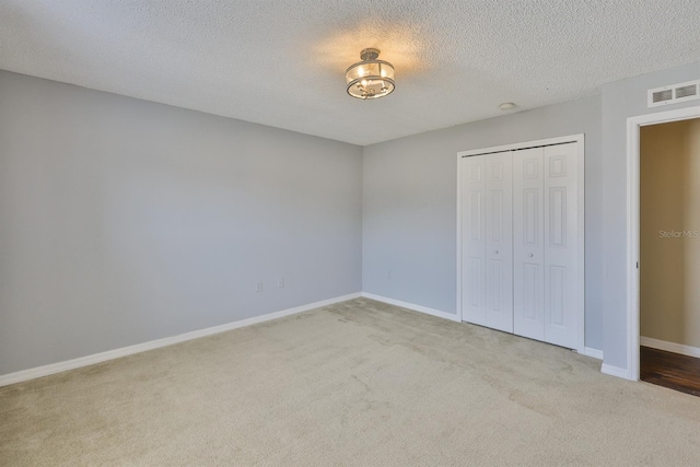 11438 Ivy Flower Loop, Riverview, FL 33578 - unfurnished bedroom featuring carpet, a closet, and a textured ceiling