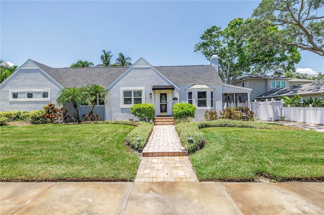555 21st Ave NE, Saint Petersburg, FL 33704 - view of front of property with a chimney and a shingled roof