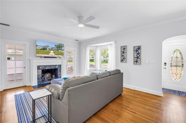 555 21st Ave NE, Saint Petersburg, FL 33704 - living area with ceiling fan, a premium fireplace, crown molding, light wood finished floors, and arched walkways