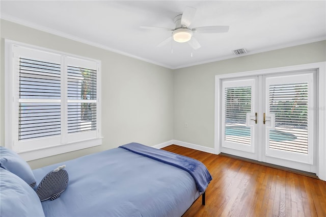 555 21st Ave NE, Saint Petersburg, FL 33704 - bedroom with access to outside, multiple windows, hardwood / wood-style flooring, ornamental molding, and french doors