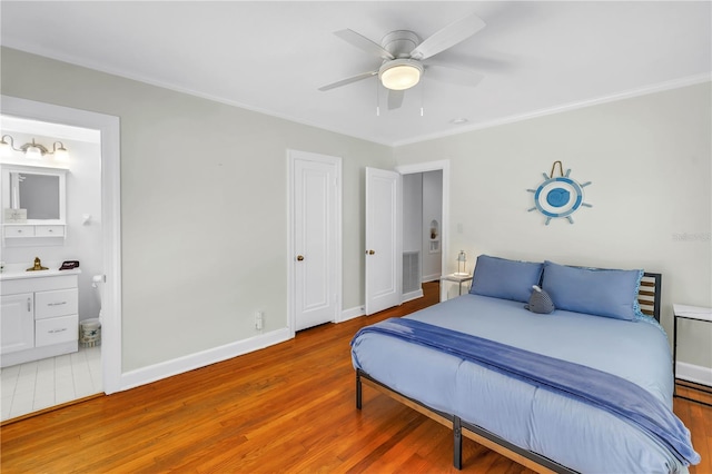 555 21st Ave NE, Saint Petersburg, FL 33704 - bedroom featuring wood finished floors, ornamental molding, ensuite bath, and a ceiling fan