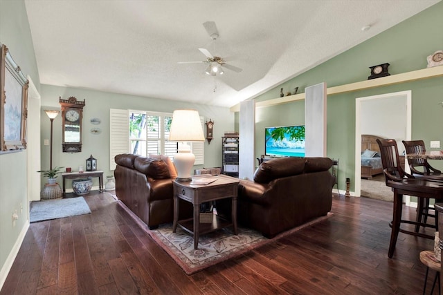 10597 Alvarado Ct, Seminole, FL 33772 - living room with lofted ceiling, ceiling fan, dark wood-style floors, and a textured ceiling