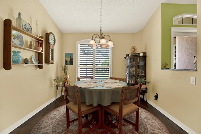 10597 Alvarado Ct, Seminole, FL 33772 - dining area featuring a chandelier, dark wood-style floors, and a textured ceiling