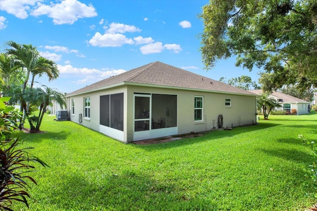 10597 Alvarado Ct, Seminole, FL 33772 - rear view of property with a yard, stucco siding, a sunroom, and a shingled roof