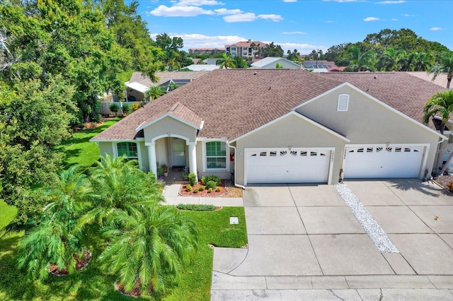 10597 Alvarado Ct, Seminole, FL 33772 - mediterranean / spanish-style home featuring driveway, an attached garage, roof with shingles, and stucco siding