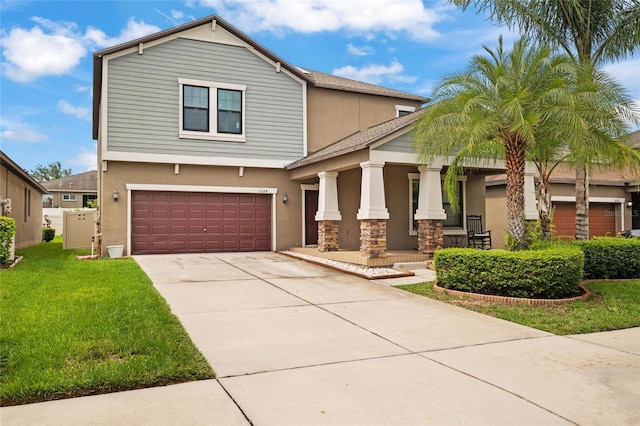 11024 Purple Martin Blvd, Riverview, FL 33579 - view of front of house featuring covered porch, stucco siding, a garage, a front lawn, and driveway