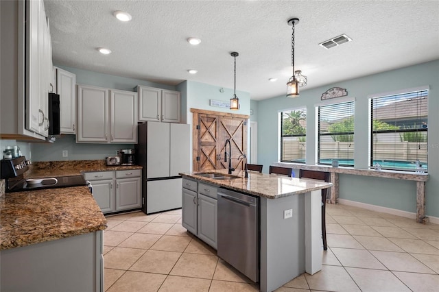 11024 Purple Martin Blvd, Riverview, FL 33579 - kitchen with stainless steel appliances, gray cabinets, light tile patterned flooring, pendant lighting, and a textured ceiling