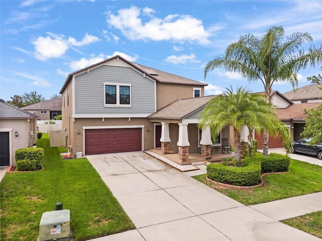 11024 Purple Martin Blvd, Riverview, FL 33579 - view of front of property featuring a garage, a porch, concrete driveway, and stucco siding