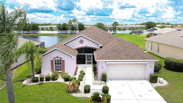 2226 N Creek Ct, Sun City Center, FL 33573 - view of front facade featuring stucco siding, driveway, an attached garage, and roof with shingles