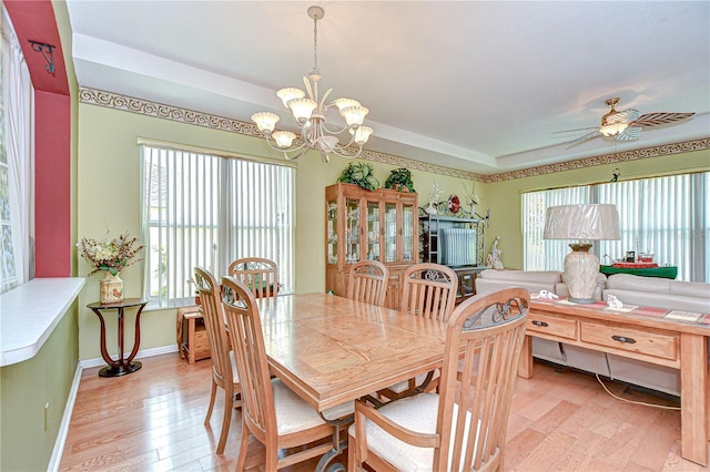2226 N Creek Ct, Sun City Center, FL 33573 - dining room featuring light wood-style floors, a chandelier, and a ceiling fan