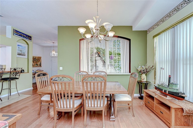 2226 N Creek Ct, Sun City Center, FL 33573 - dining room with light wood-type flooring and a chandelier
