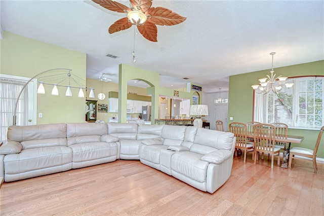 2226 N Creek Ct, Sun City Center, FL 33573 - living room with a chandelier, light wood-type flooring, and a ceiling fan