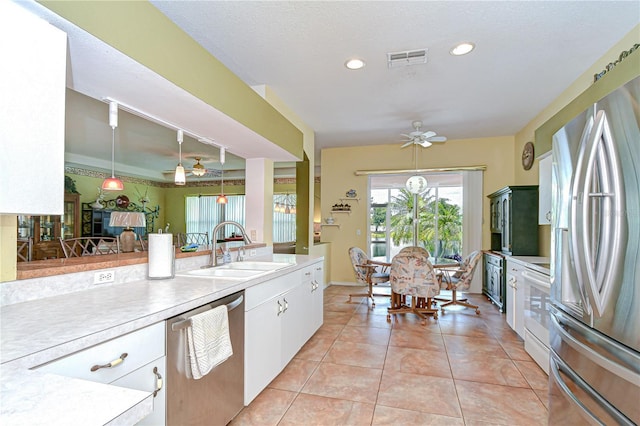 2226 N Creek Ct, Sun City Center, FL 33573 - kitchen featuring appliances with stainless steel finishes, ceiling fan, light countertops, light tile patterned floors, and recessed lighting