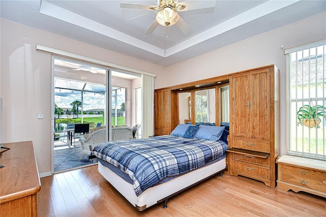 2226 N Creek Ct, Sun City Center, FL 33573 - bedroom featuring access to outside, light wood-style flooring, and multiple windows