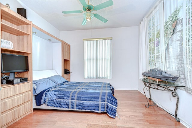 2226 N Creek Ct, Sun City Center, FL 33573 - bedroom featuring wood finished floors and a ceiling fan